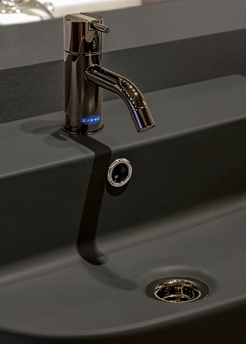 近年トレンドとなっているマットグレーの洗面器とブラッククロム湯水混合栓（169,500円）の組み合わせ例。水栓と同色の目皿もオプションで用意されている ※表示価格は税抜価格