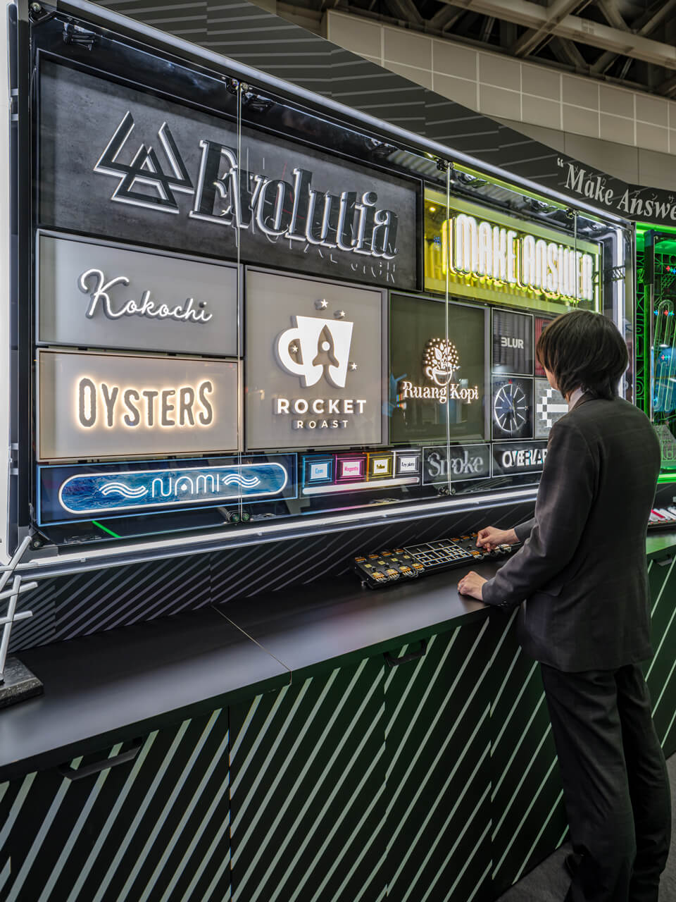 さまざまなLEDサインのプロトタイプを並べたコーナー。手元の機械で実際に、調光調色の操作も行われた